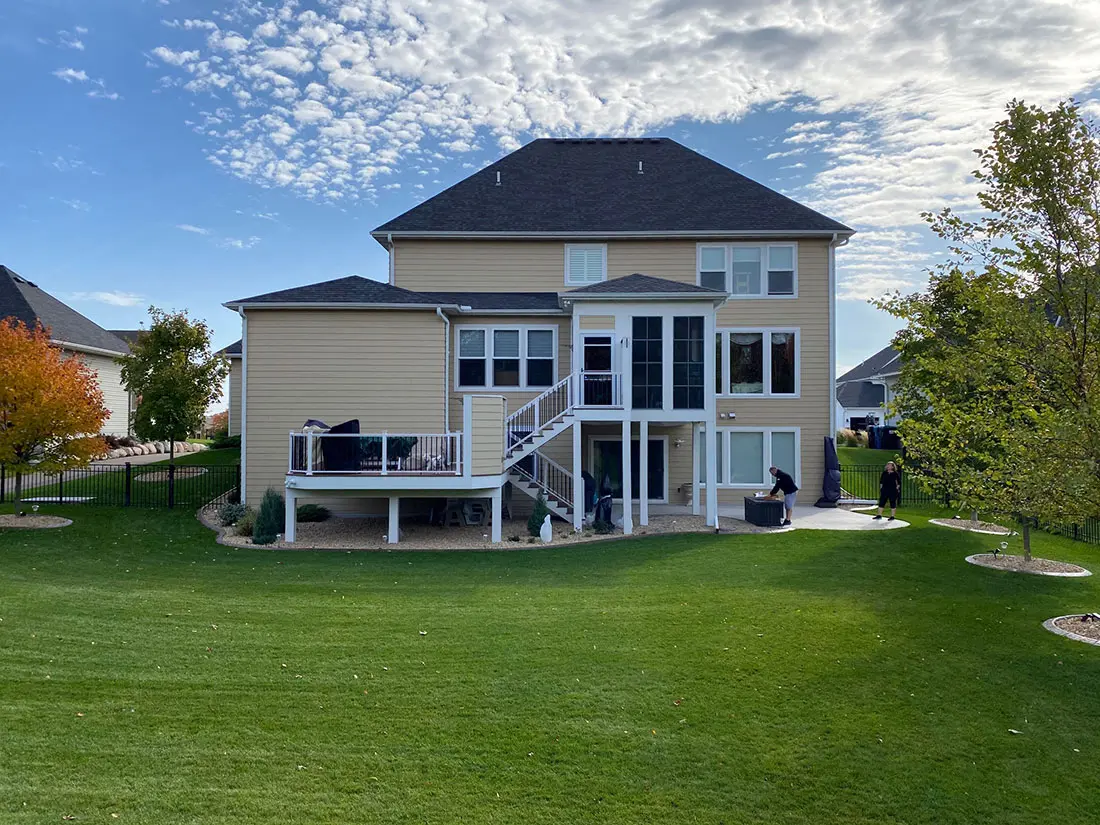Covered porch addition with adjacent outdoor deck