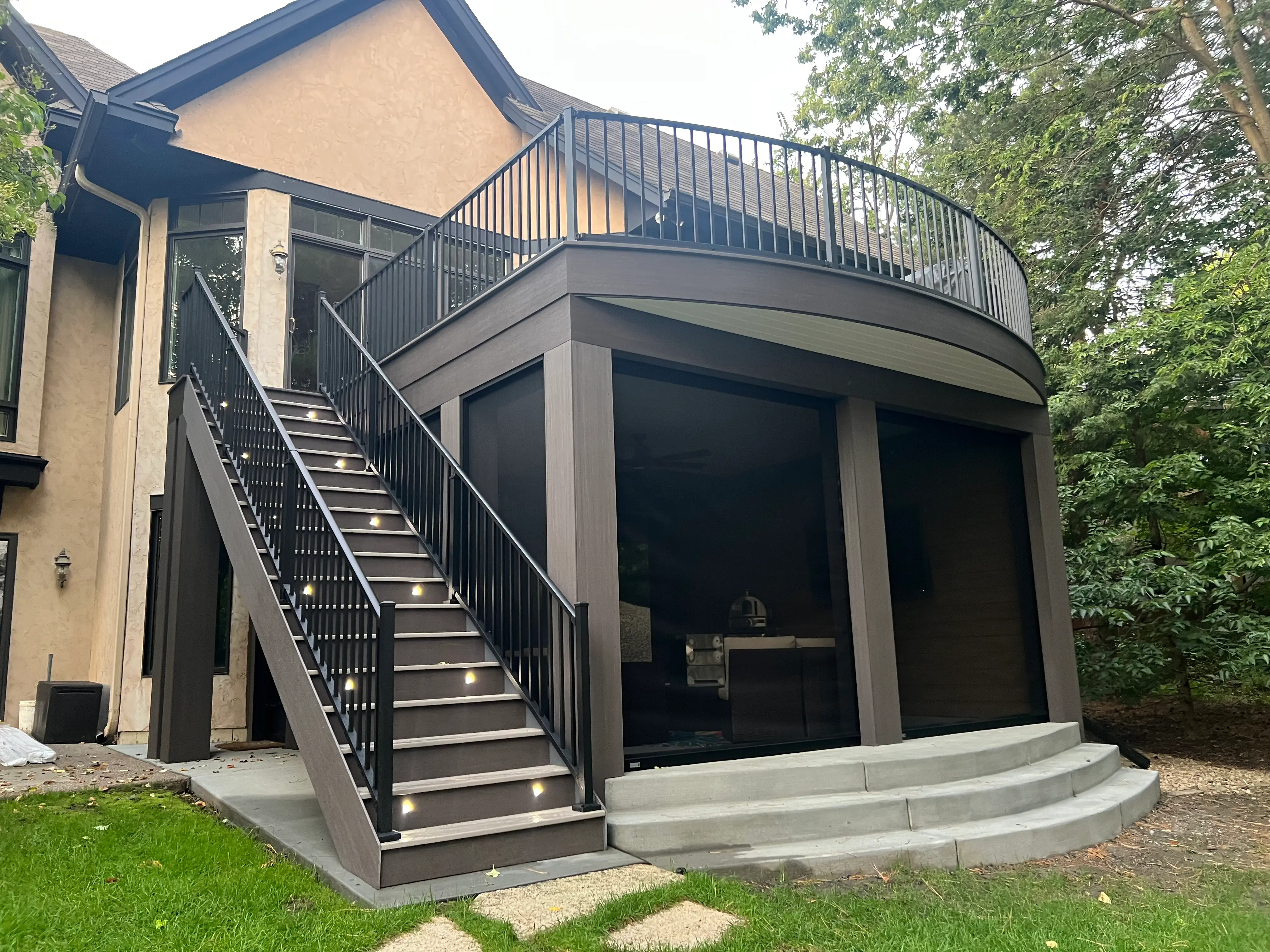 Elevated deck above a curved concrete patio