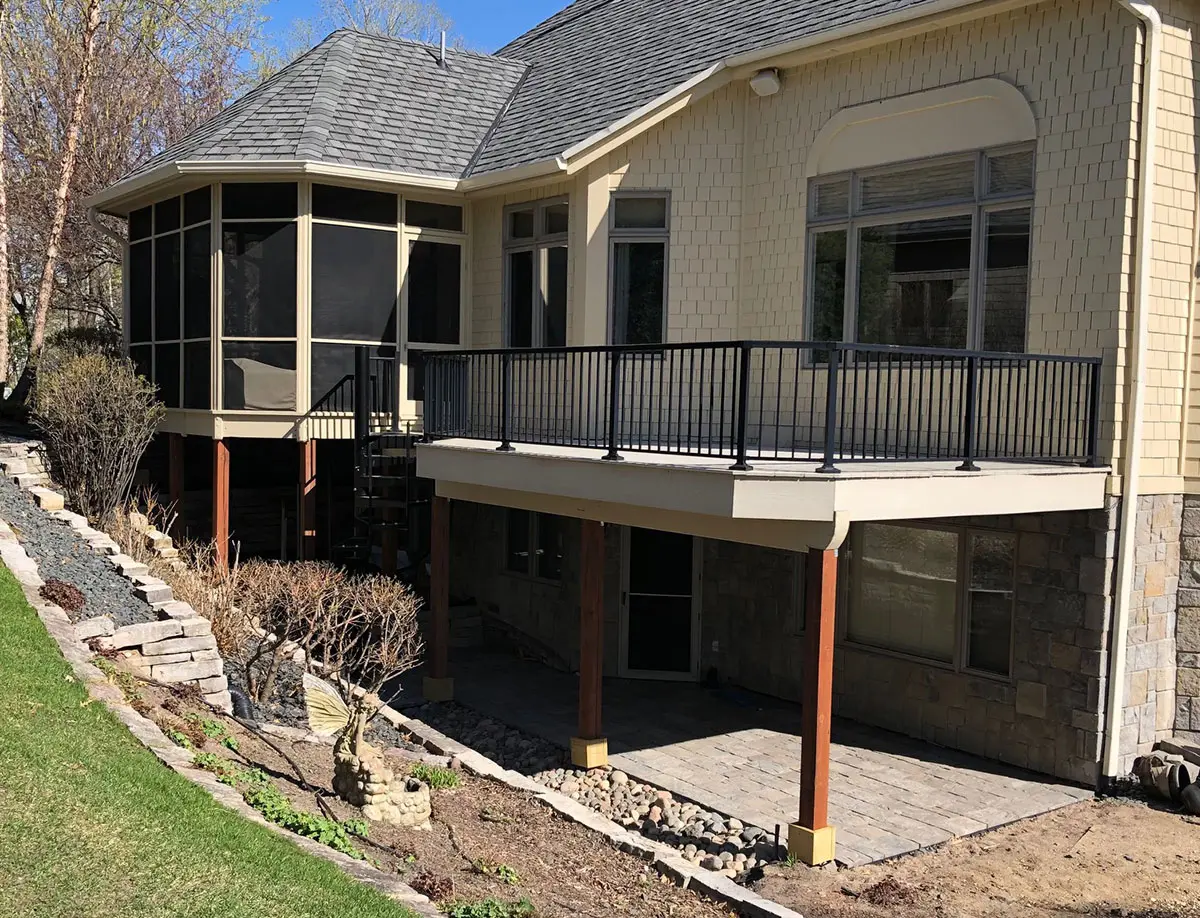 Screened porch and deck addition beside a suburban home